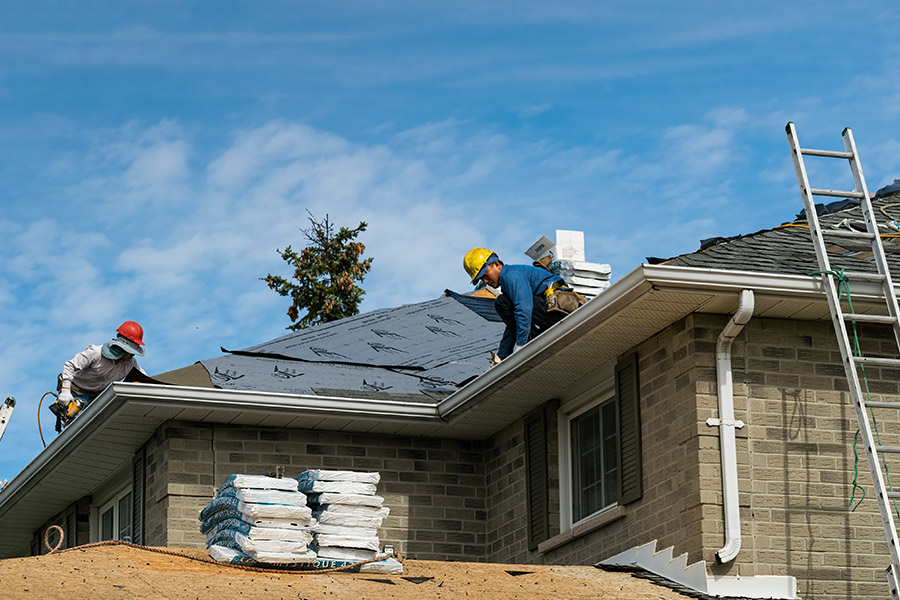 contractors repairing asphalt shingles roof at residential property jacksonville fl